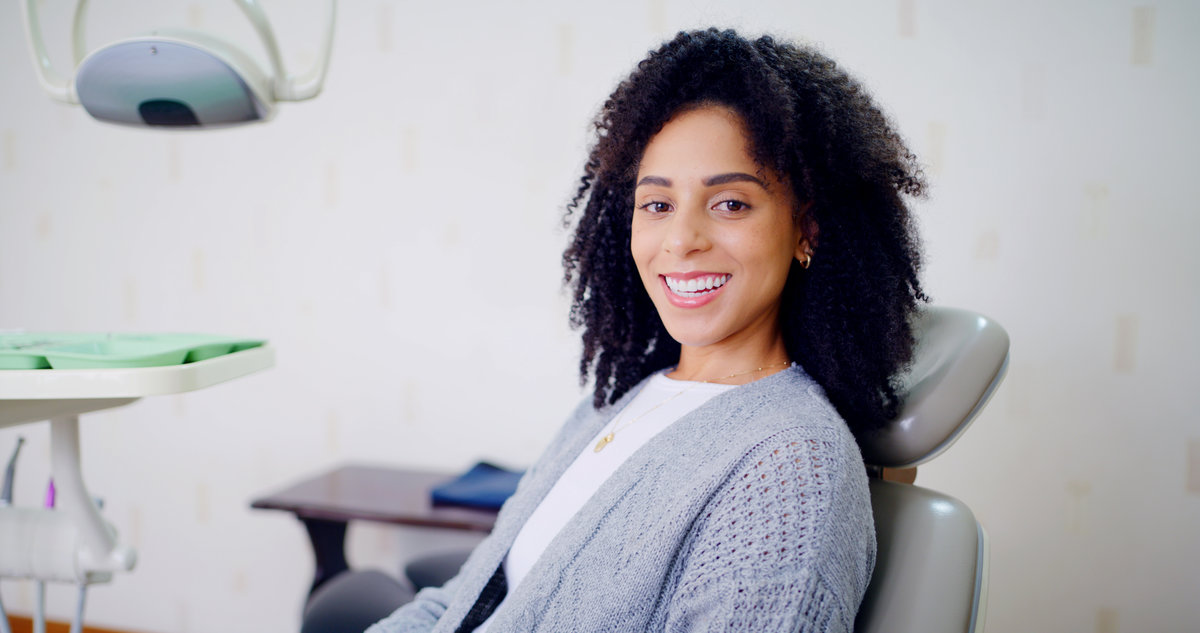 Portrait, woman and smile for dental care, clinic and confident for medical procedure or appointment. Happy, patient and oral health for person, healthcare and tooth extraction services in office.