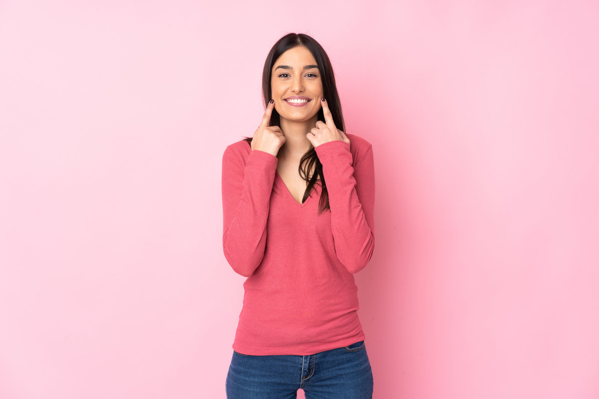 Young caucasian woman over isolated background smiling with a happy and pleasant expression